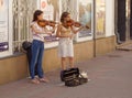 Street musicians playing violins