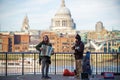 Street musicians on the South Bank with St Paul`s Cathedral in the background Royalty Free Stock Photo