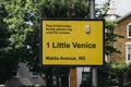 Street name sign, a bell and delivery instructions for a boat moored in Little Venice, London, UK