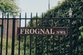 Street name sign on a metal fence on Frognal, Hampstead, London, UK