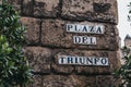 Street name sign on Plaza del Triunfo in Seville, Spain