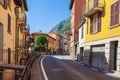 Street near of beatiful Lake Como in Lombardy, Italy. Scenic small town with traditional houses and clear blue water. Summer