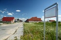 Street with newly built houses and empty sign