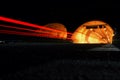 Street at night with red trails of cars in front of a tunnel Royalty Free Stock Photo