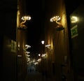 Street at night in siena. typical street lamps in Siena