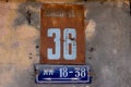 Street number 36 on a metal placard