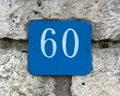 Street Number 60 on a Stone Wall Royalty Free Stock Photo