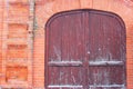 Street with old brick houses. 100 year old house with beautiful old wooden gates. on a snowy winter day Royalty Free Stock Photo