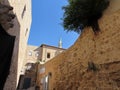 Street in the old city of Acre in Israel. Nice view of the minaret against the blue sky.