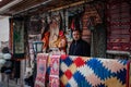 Street of the old city with traditional Azerbaijani carpets on the wall and the seller