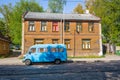 On the street old passenger mini bus and wooden building Royalty Free Stock Photo