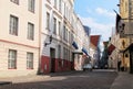 Street of Old Tallinn. Medieval houses, facades. On the houses are Estonian, Russian and Finnish flags
