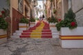 Street of the old town in the center of Calpe with the staircase painted with the colors of the Spanish flag, Alicante. Spain