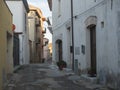 Street in old town of Tortoli with white, yellow and pink houses. Sardinia, Italy, summer afternoon