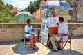 Street painter on Charles Bridge in Prague. Royalty Free Stock Photo