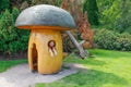 Street park with a talk room in the form of a wooden mushroom and a cheerful girl looking out of a window in Kalmar Royalty Free Stock Photo