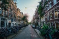 Street with parked bicycles next to residential houses in Amsterdam, Netherlands