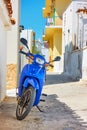 Street with parked motor scooter in Perdika