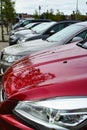 Street parking cars along sidewalk near large shopping center