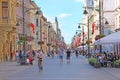 Street with pedestrians and cyclist in Lodz. Young man athlete rides sports bike