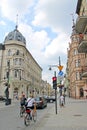 Street with pedestrians and cyclist in Lodz. Young man athlete rides sports bike