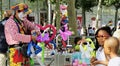 Street Performer Clown entertains kids with Balloon Animals