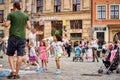 Street performer makes big bubbles on city street to entertain children and tourists. Royalty Free Stock Photo