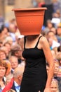 Street performer with plant pot on head