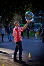 Street performer spins a soap bubble Royalty Free Stock Photo