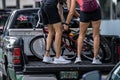 Street photo couple unloading bikes from a pick up truck