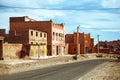 Street photo of an empty road with traditional moroccan houses in the city of Tinghir, Sahra Desert, Morocco Royalty Free Stock Photo