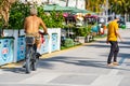 Street photo senior man riding bike shirtless on Ocean Drive Miami