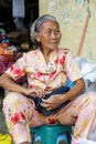 Street photo view of portraiture elder picture sale fruit at the fresh market Royalty Free Stock Photo