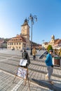 Street photographer on the central square of the old Brasov in Romania Royalty Free Stock Photo