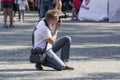 Street photographer looking through the viewfinder at the model