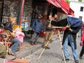 Street photographer take a photograph of tourist with bellows view camera