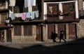 A Street Photographer walks in the Streets of Guimares, chasing light and shadows, Guimares, Portugal. Royalty Free Stock Photo