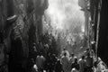 Street photographers black-and-white capture of solemn Good Friday procession in old city. Royalty Free Stock Photo