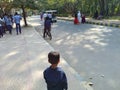 Street photography, a boy observing his surrounding keenly on a road side