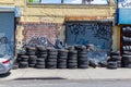 Street Photography. Brooklyn New York, Roadside used tire depot with graffiti on the wall