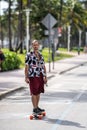 Street photography man riding electric skateboard Miami Beach Ocean Drive