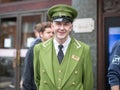 London, United Kingdom- Street Photography: Portrait of Harrods Department Store Receptionist with Green Uniform and Hat in London