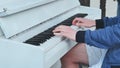 A street pianist plays the piano in the city.