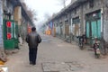 Man in misty street in rustic Pingyao Ancient walled City (Unesco), China
