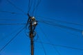 Street pole with many electrical wires and fiber optic cables, Fiber-optic cable against the blue sky Royalty Free Stock Photo