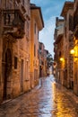 Street in Porec town illuminated by lamps at the evening.