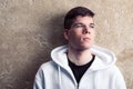 Street portrait of blue eye young boy in white sweatshirt