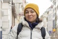 street portrait of a chubby woman 40-45 years old on a blurred background of a European city