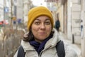 street portrait of a chubby woman 40-45 years old on a blurred background of a European city