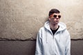 Street portrait of young boy in white sweatshirt with orange mod